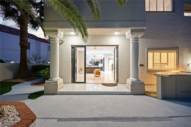 property entrance with stucco siding