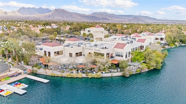 drone / aerial view with a residential view and a water and mountain view