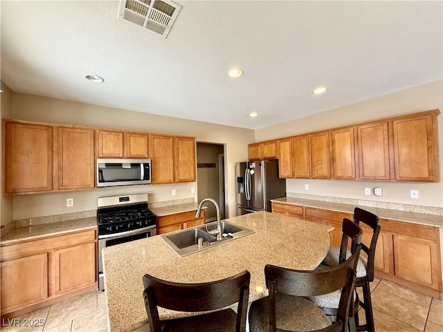 kitchen with a sink, light countertops, visible vents, and stainless steel appliances