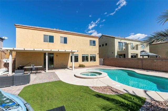 view of swimming pool featuring a patio area, a pool with connected hot tub, a yard, and fence