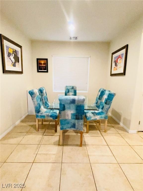 dining space featuring light tile patterned floors, baseboards, and visible vents