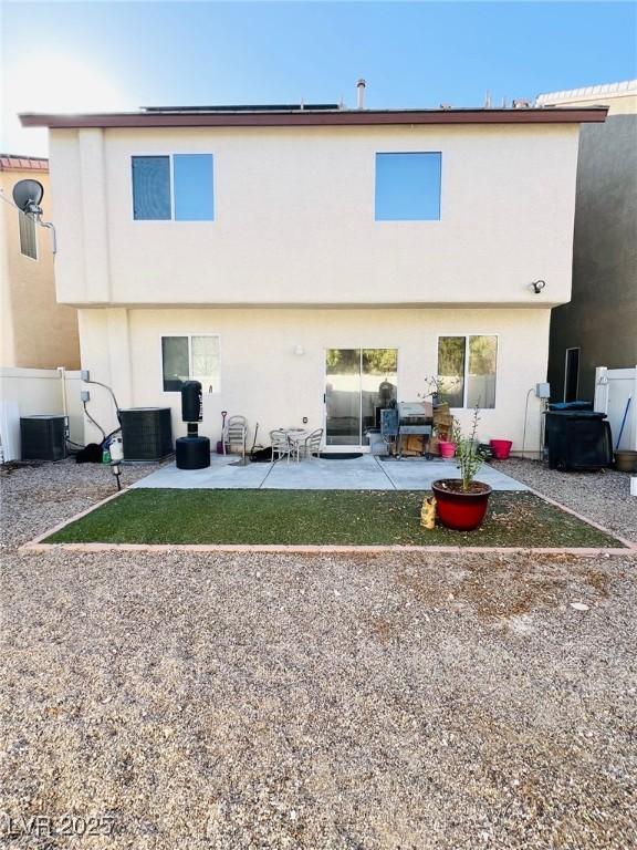 rear view of house featuring cooling unit, a patio, fence, and stucco siding