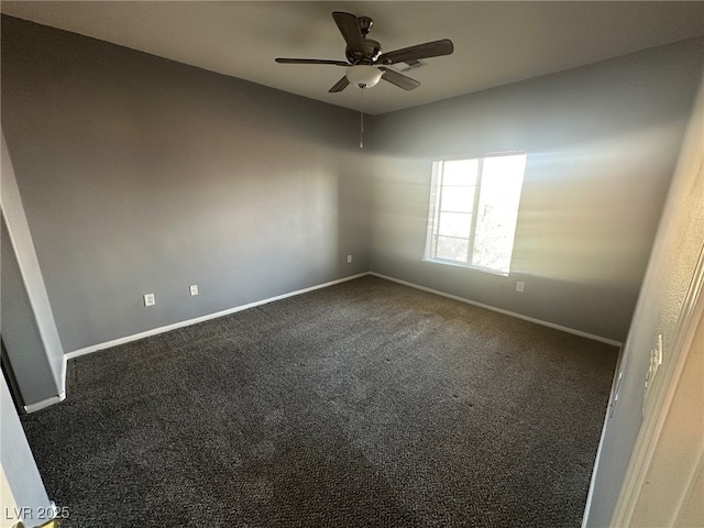 empty room with dark carpet, baseboards, and ceiling fan