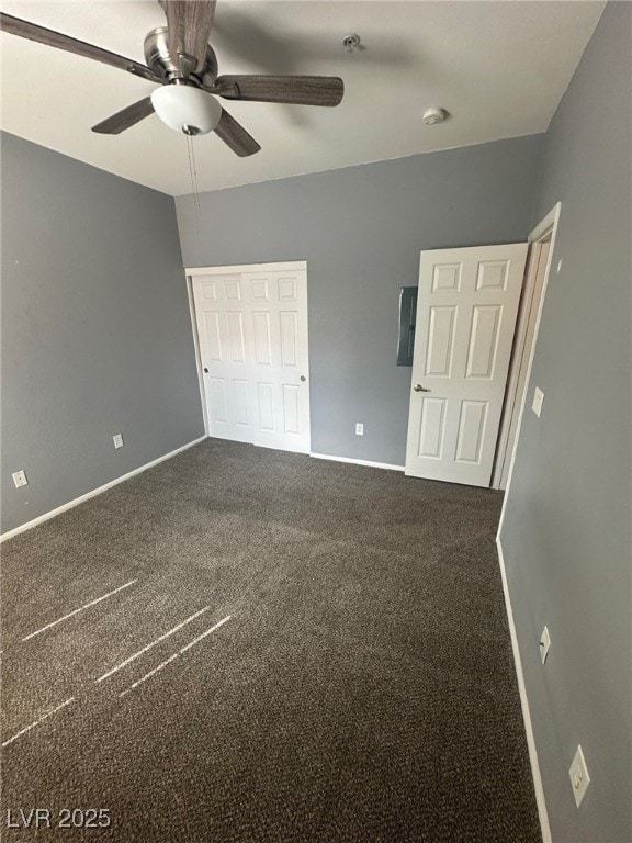 unfurnished bedroom featuring a ceiling fan, carpet, baseboards, and a closet