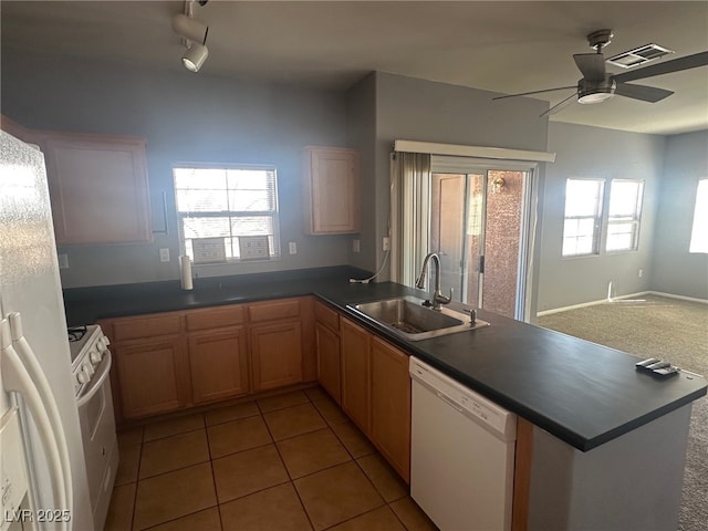 kitchen with white appliances, a ceiling fan, visible vents, a peninsula, and a sink