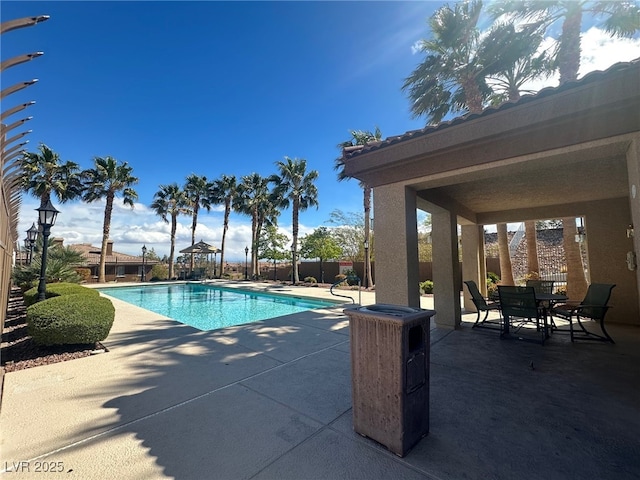 view of pool with a fenced in pool, a patio, and fence