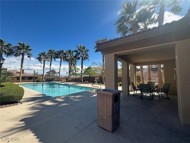 pool with fence and a patio area