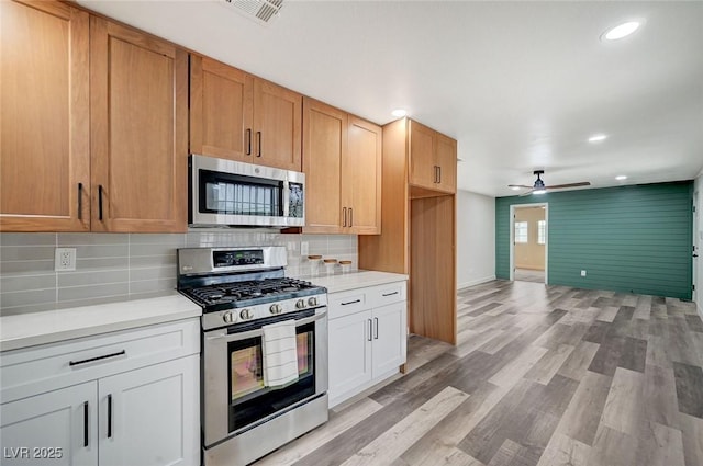 kitchen with light countertops, a ceiling fan, visible vents, and appliances with stainless steel finishes