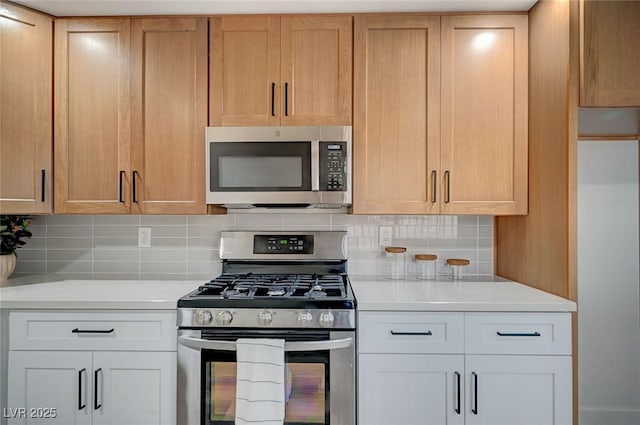 kitchen with backsplash, appliances with stainless steel finishes, and light countertops