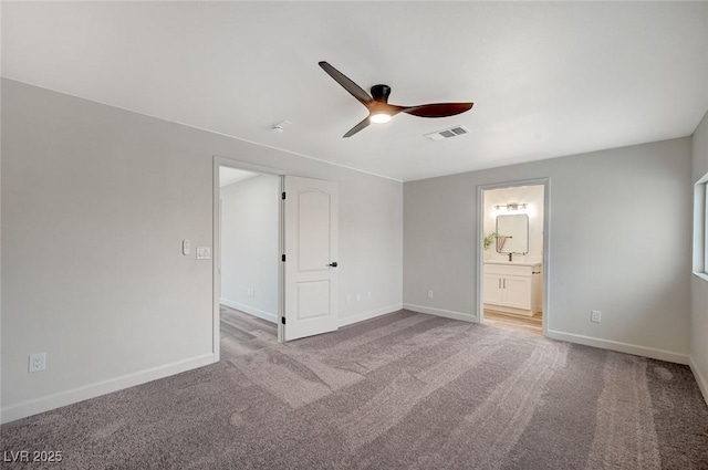 unfurnished bedroom with visible vents, baseboards, ensuite bathroom, and carpet