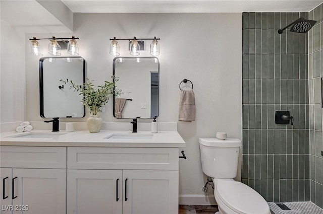 full bathroom with double vanity, toilet, and a sink