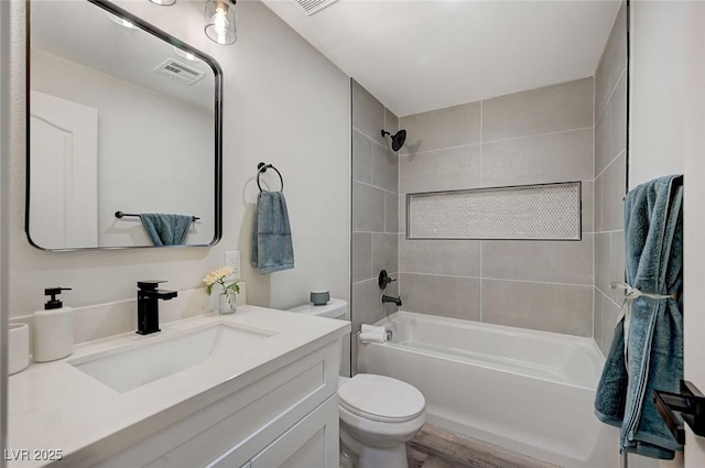 full bath with vanity, toilet, tub / shower combination, and visible vents