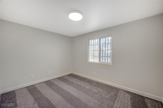 unfurnished room with baseboards and carpet