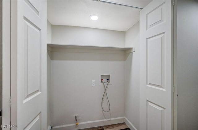 laundry room with baseboards, washer hookup, and wood finished floors