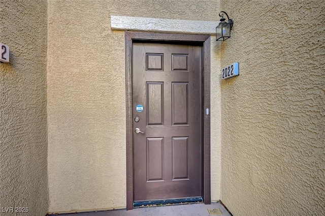 property entrance featuring stucco siding