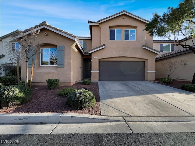 mediterranean / spanish-style house featuring stucco siding, a garage, concrete driveway, and a tiled roof