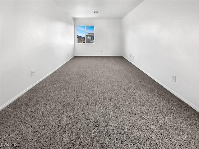 unfurnished room with carpet flooring, visible vents, and baseboards