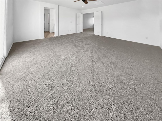 unfurnished bedroom featuring a ceiling fan and carpet