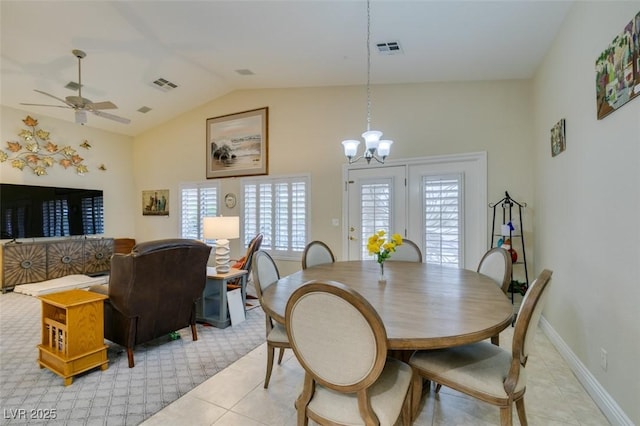 dining room featuring vaulted ceiling, ceiling fan with notable chandelier, visible vents, and baseboards