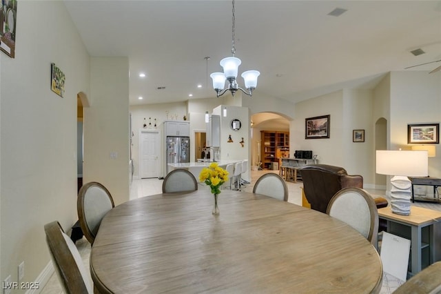 dining area with recessed lighting, arched walkways, baseboards, a chandelier, and vaulted ceiling