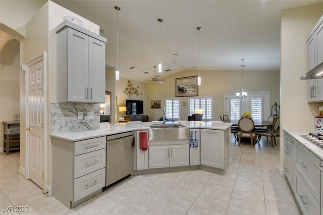 kitchen with backsplash, dishwasher, a peninsula, arched walkways, and a sink