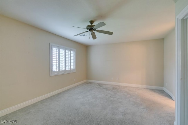 carpeted empty room with baseboards and a ceiling fan