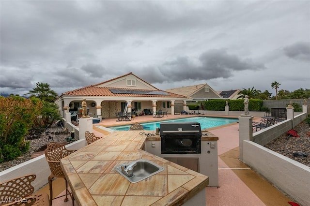 view of pool with outdoor dining space, fence, a patio area, and a fenced in pool