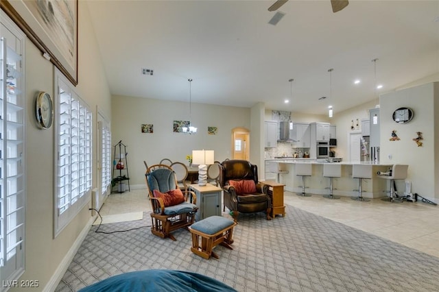 living room with visible vents, a ceiling fan, recessed lighting, light tile patterned floors, and baseboards