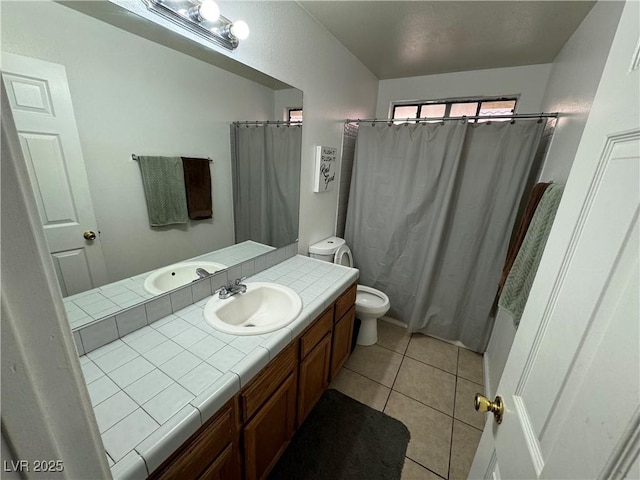 bathroom with vanity, tile patterned floors, curtained shower, and toilet