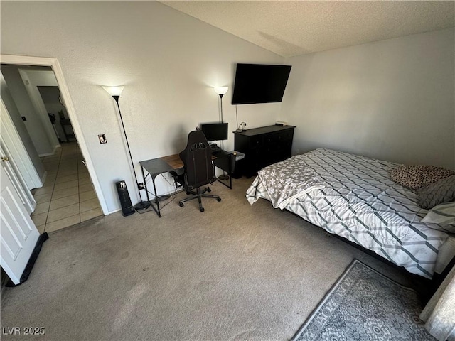 bedroom featuring tile patterned floors, a textured ceiling, carpet flooring, and vaulted ceiling