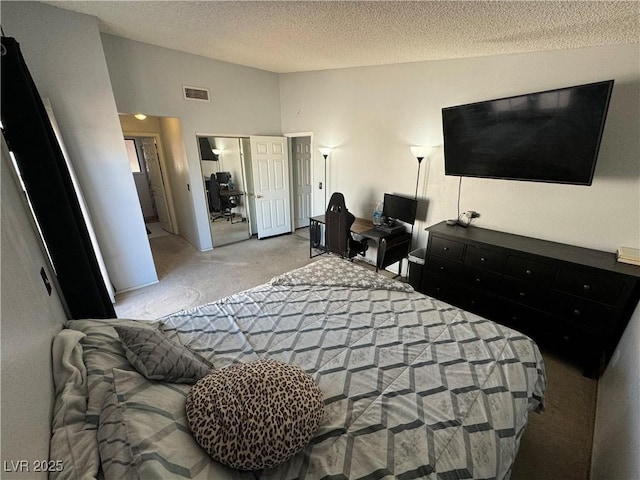 bedroom featuring carpet, visible vents, vaulted ceiling, a closet, and a textured ceiling