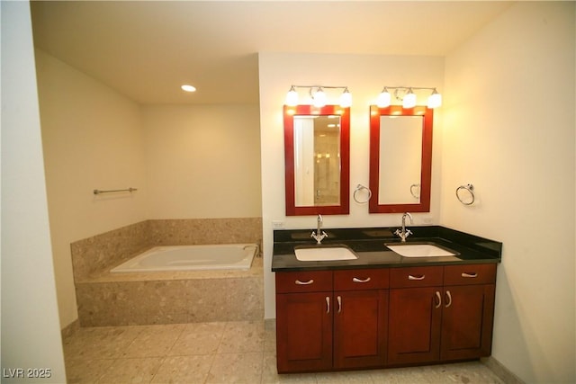 full bath featuring tile patterned flooring, double vanity, a bath, and a sink