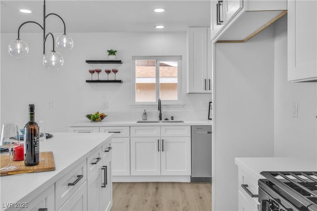 kitchen with dishwasher, light countertops, and a sink