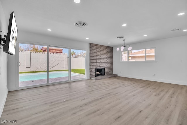 unfurnished living room with visible vents, recessed lighting, baseboards, and wood finished floors