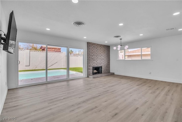 unfurnished living room featuring visible vents, recessed lighting, baseboards, and wood finished floors