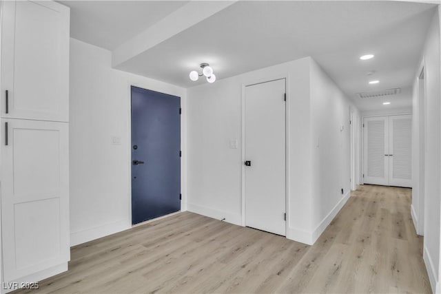 foyer with recessed lighting, visible vents, baseboards, and light wood-style flooring