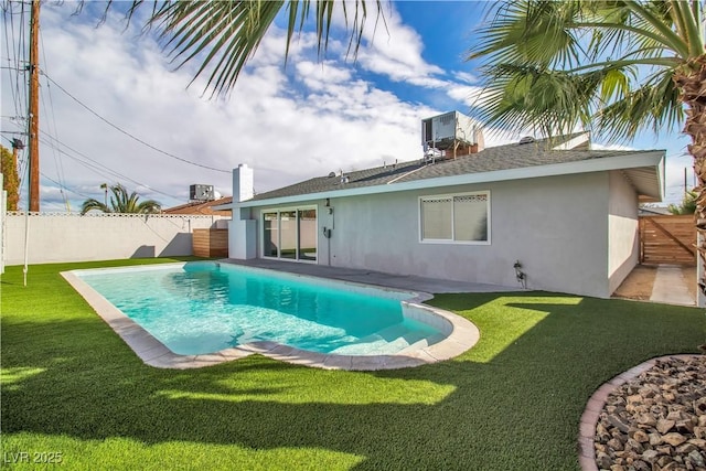 view of swimming pool featuring a fenced in pool, a lawn, and a fenced backyard