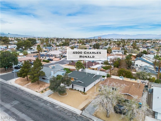 drone / aerial view featuring a mountain view and a residential view