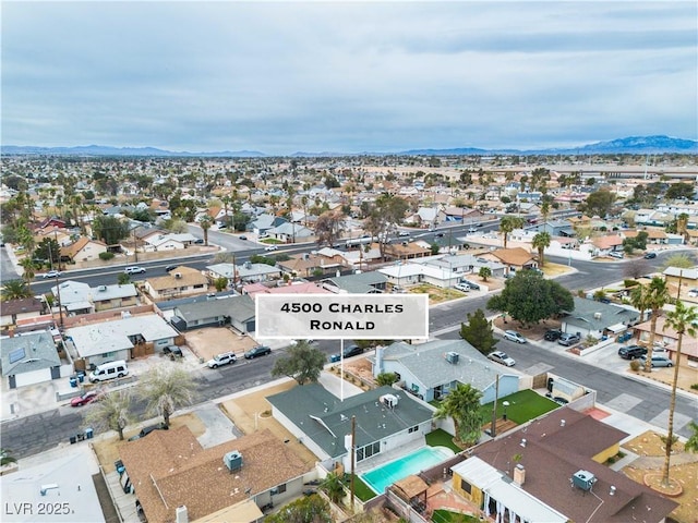 drone / aerial view featuring a residential view and a mountain view