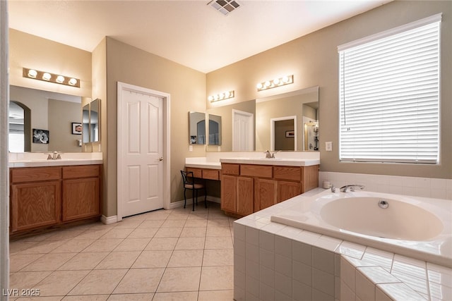 bathroom featuring a sink, visible vents, a garden tub, and tile patterned flooring