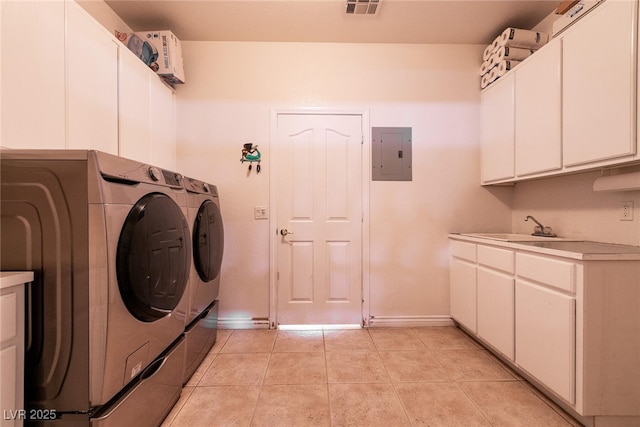 clothes washing area with light tile patterned flooring, electric panel, cabinet space, a sink, and independent washer and dryer