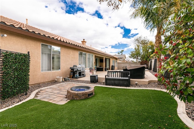 view of yard featuring a patio, fence, and an outdoor fire pit