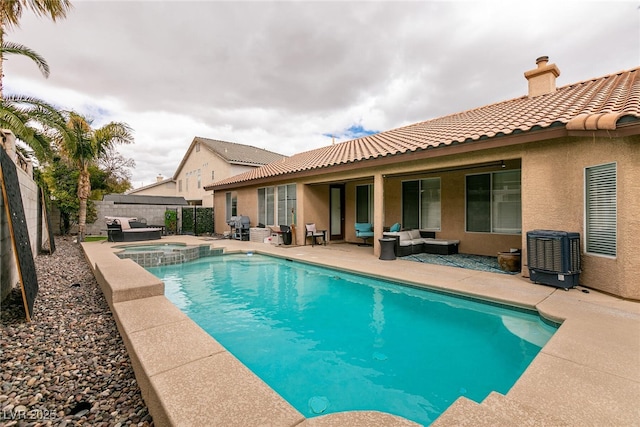 view of pool featuring central air condition unit, a pool with connected hot tub, an outdoor living space, a patio, and a fenced backyard