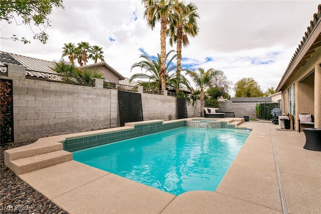 view of pool featuring a patio area, a pool with connected hot tub, and a fenced backyard