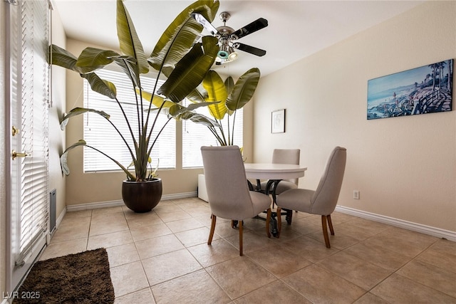 dining room featuring light tile patterned flooring, baseboards, and ceiling fan