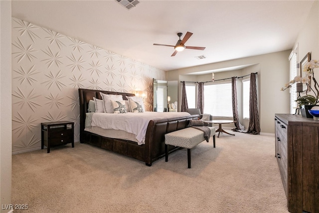 bedroom with visible vents, carpet floors, ceiling fan, and wallpapered walls