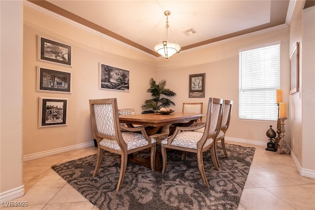 dining space featuring light tile patterned floors, visible vents, baseboards, and ornamental molding