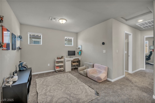 carpeted office space with visible vents and baseboards