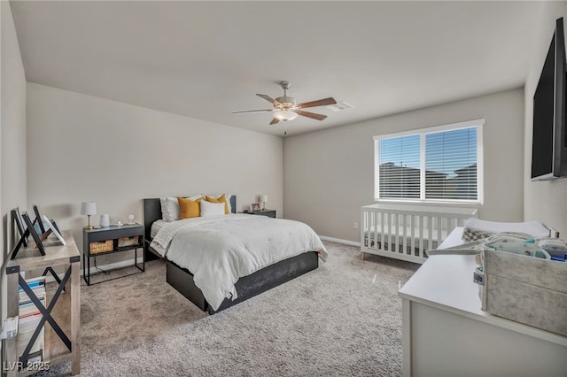 carpeted bedroom featuring visible vents, baseboards, and a ceiling fan