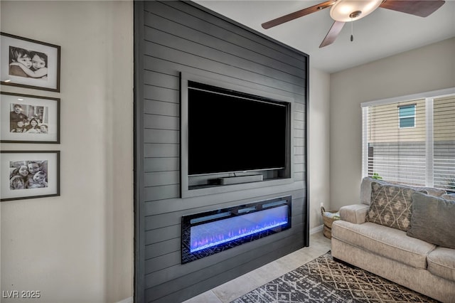 living area with ceiling fan and a fireplace